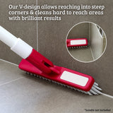 A red and white floor cleaning mop head shown on a gray tiled floor corner, with white text explaining its V-design for reaching corners and a circular inset showing the brush contact detail. A small note says handle not included.